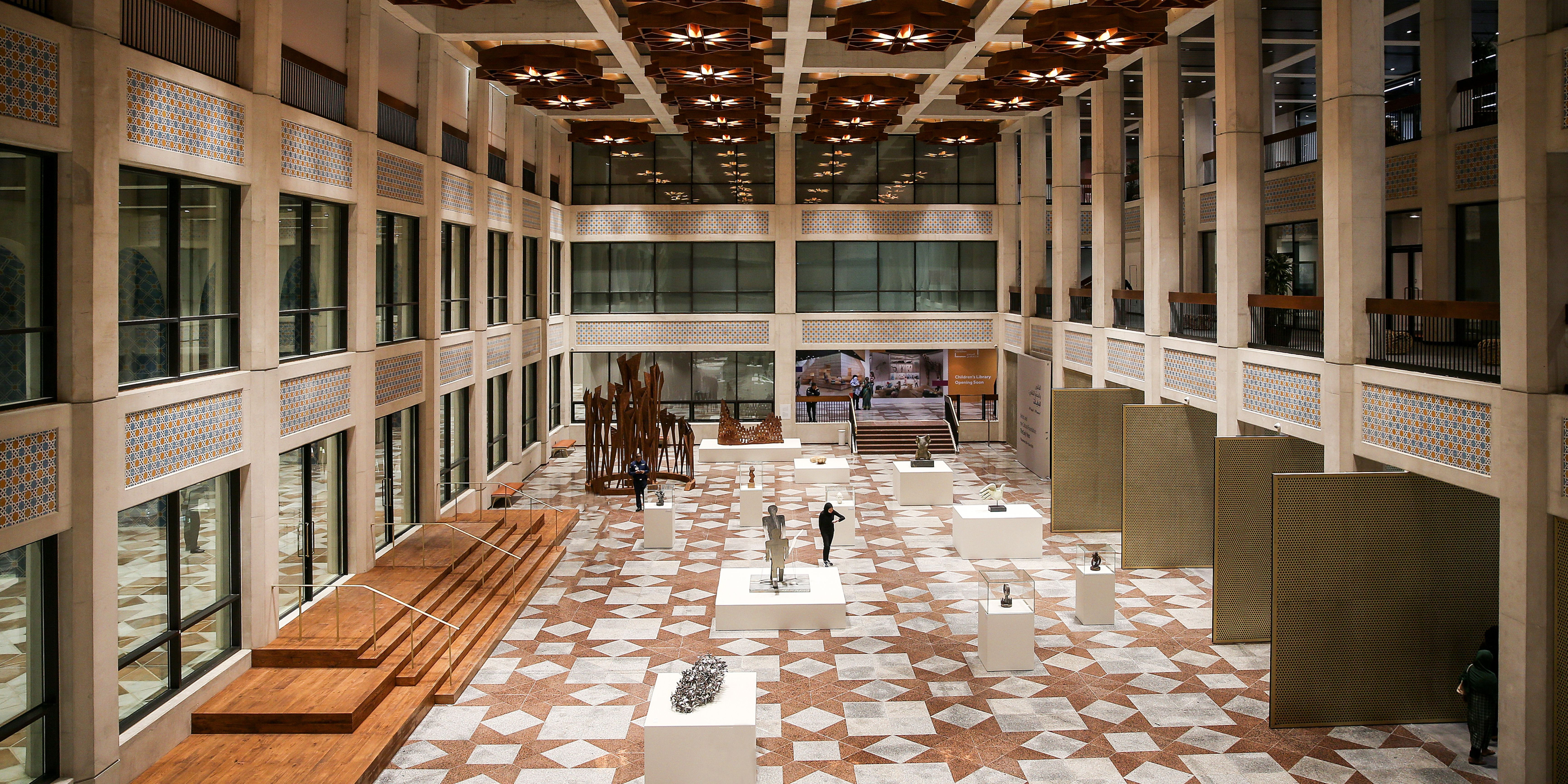 Interior of the Stavros Niarchos Foundation Cultural Center showing an exhibition space with sculptures and installations.
